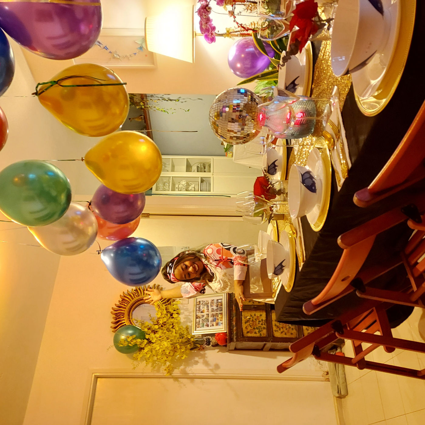 Chef Novy hosting a birthday dinner party — styled long table with balloons, a disco-ball centrepiece and a full banquet setting